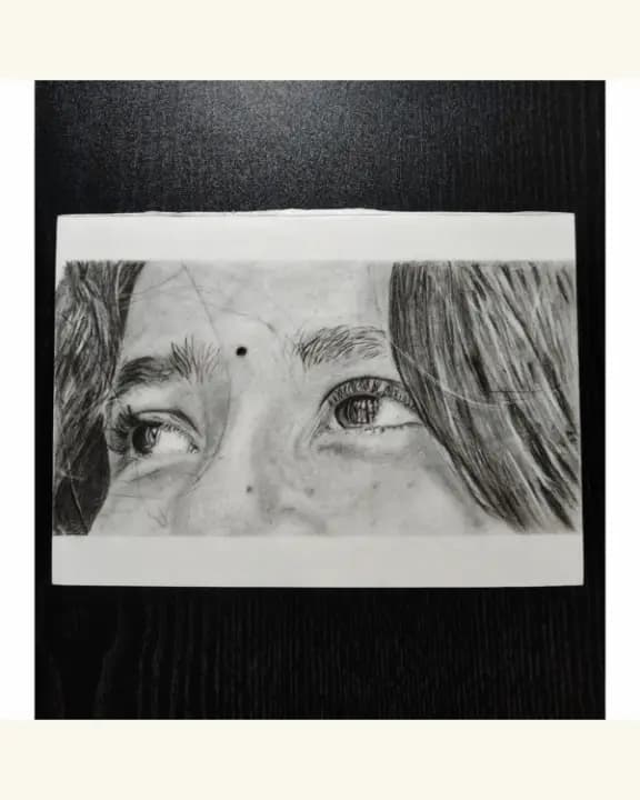 Handmade pencil sketch of a girl looking up